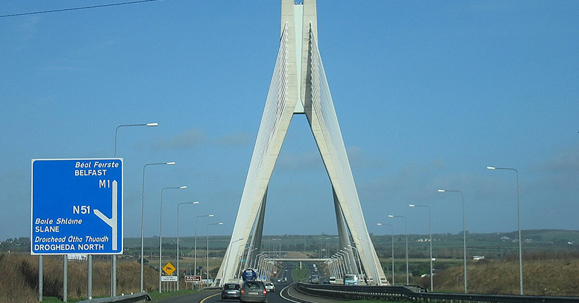 A photograph of the Mary McAleese Boyne Valley Bridge in Northern Ireland, with road signs to both the Republic of Ireland and Northern Ireland